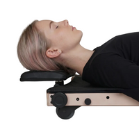 Taller user resting on the raised pillow position of Movelio Bed Roller Professional.