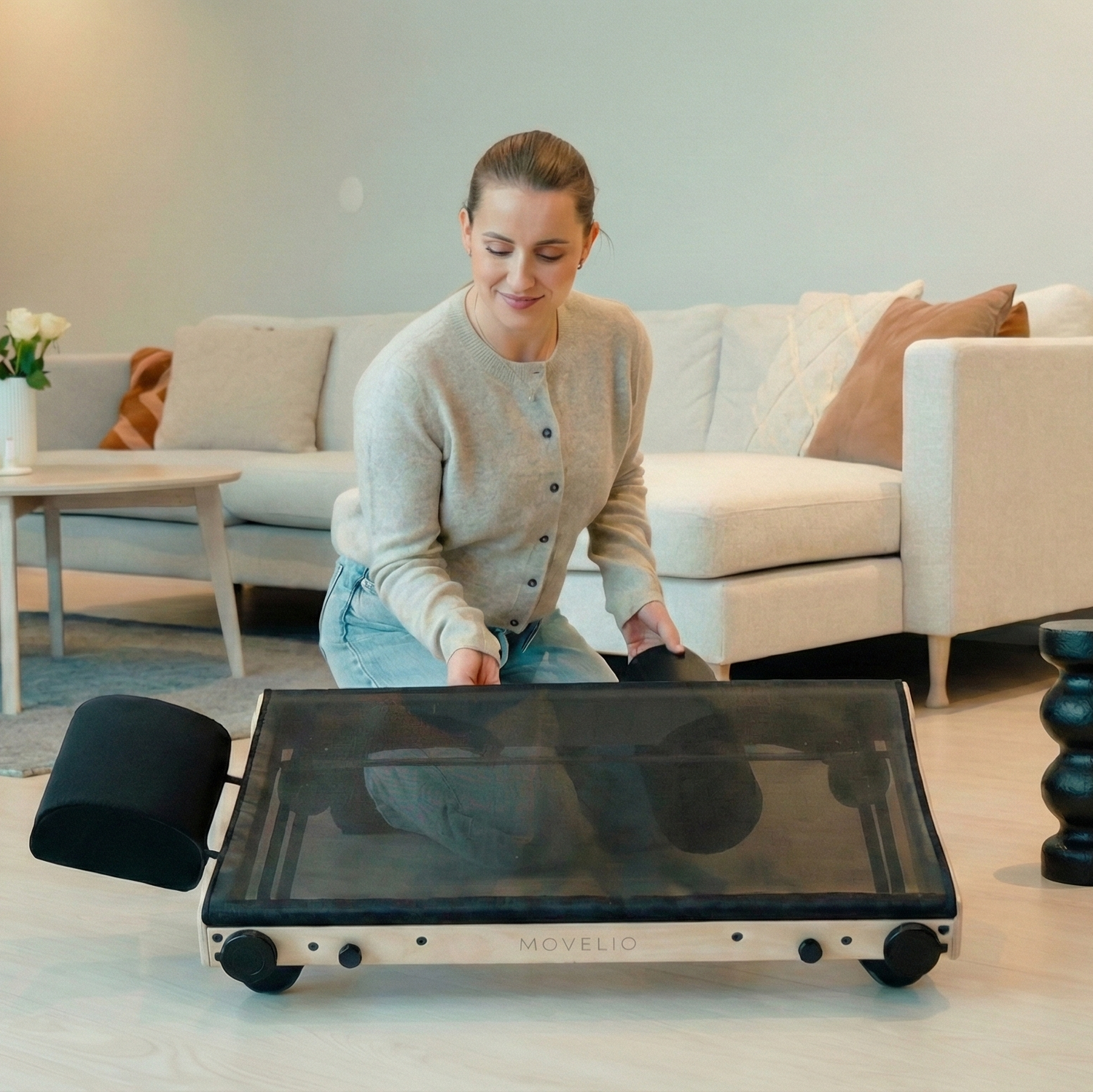 Woman using a MOVELIO product in a living room setting