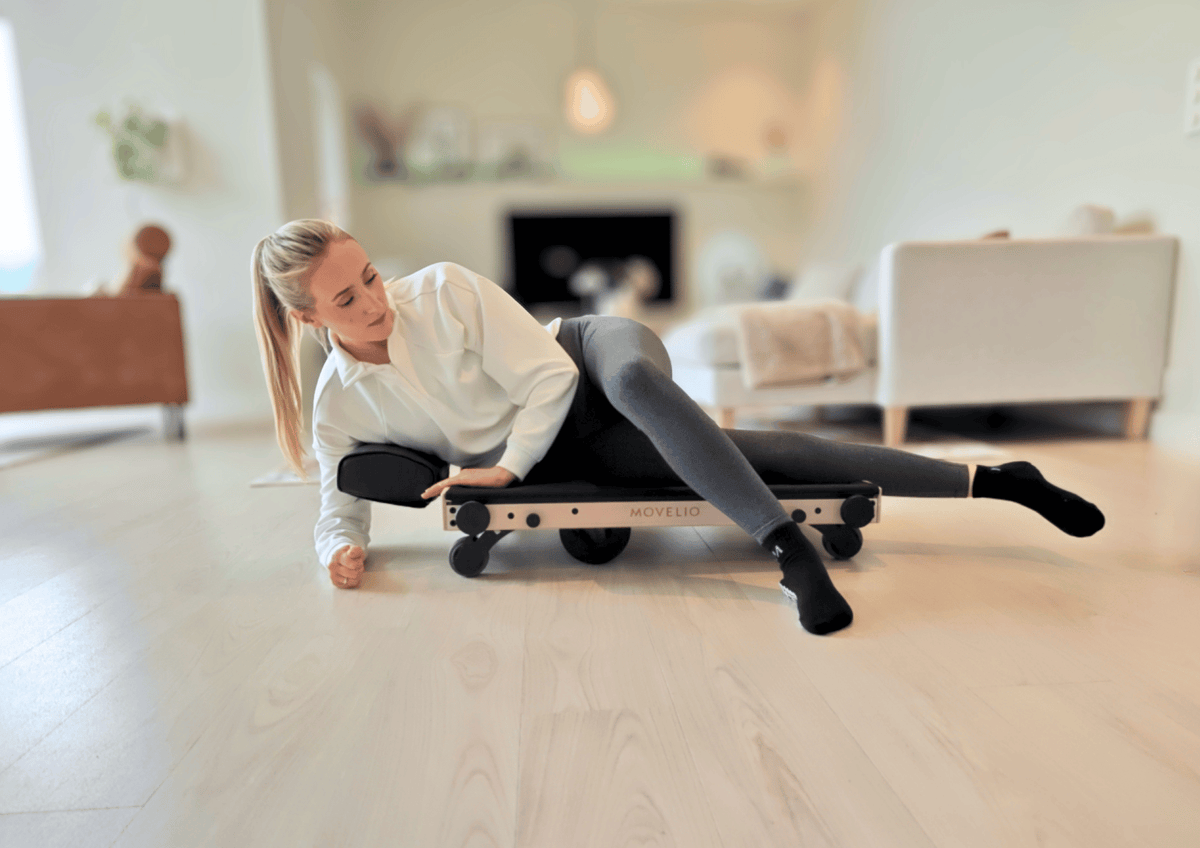 Movelio Bed Roller used at home for targeted massage across the hips and glutes