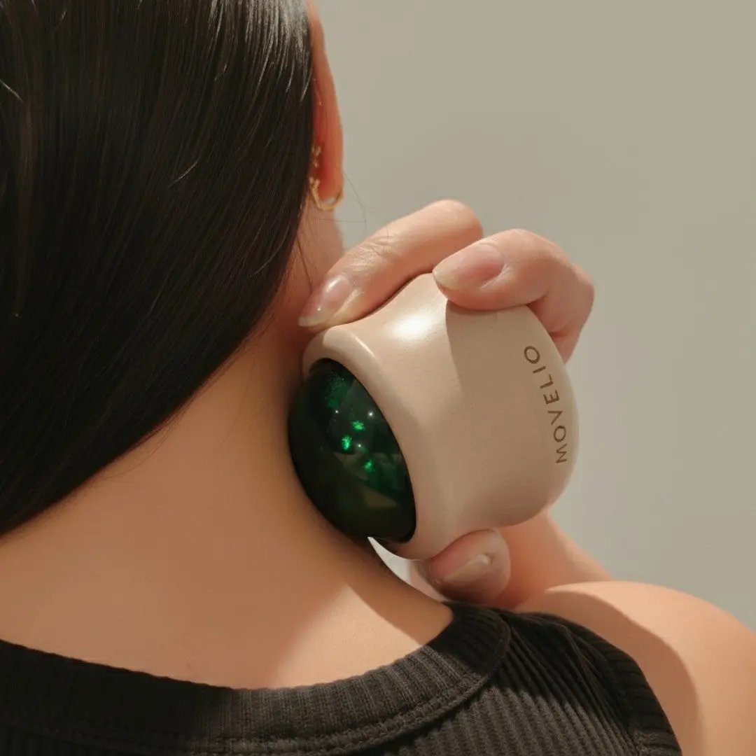 Close-up of a person using the MOVELIO Massage Ball on the neck for targeted muscle relief.