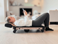 Person using Movelio Bed Roller at home while viewing the Movelio Companion App.