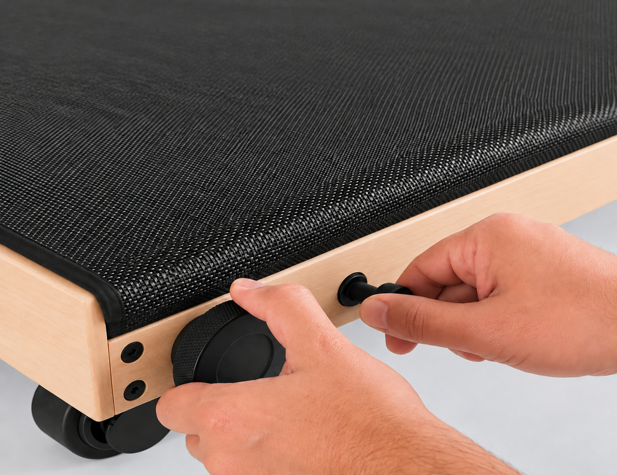Hands adjusting the frame height and massage pressure on Movelio Bed Roller.